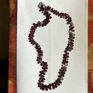 Purple 17 inch necklace.  Shiny and interesting stringing.